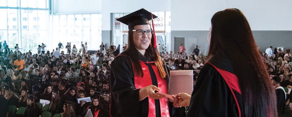Student receiving parchment at graduation
