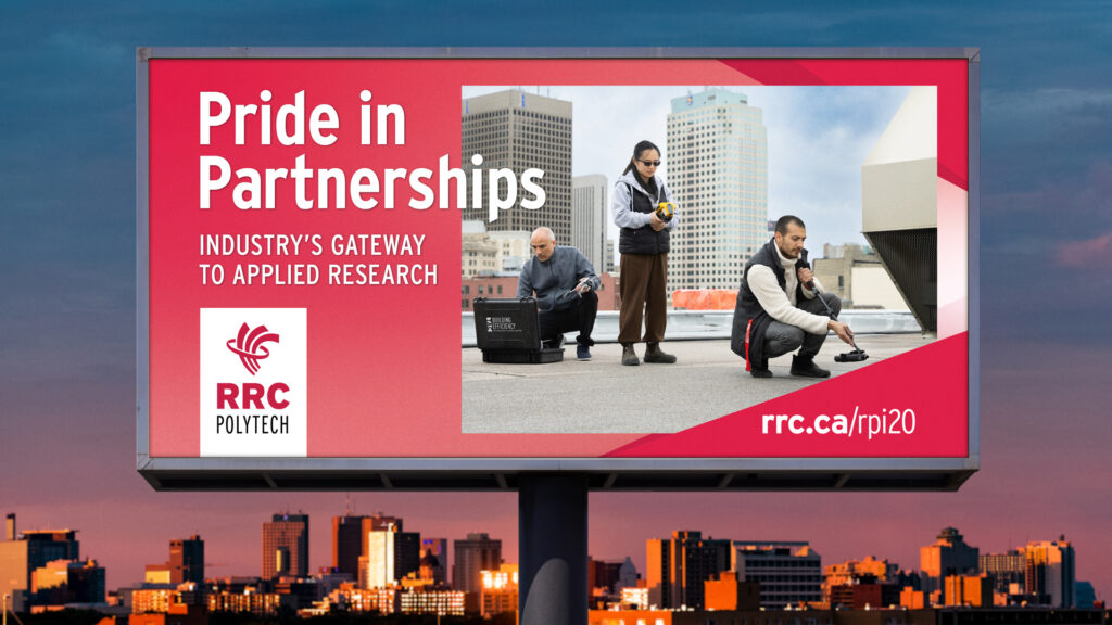 e8体育 的 Pride in Partnership 活动的广告牌，其中有一支团队正在研究温尼伯屋顶上的状况