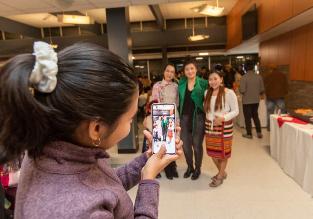 一个人为 e8体育 2023 年文化派对上的一群人拍照