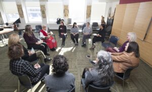 Members of RRC Polytech's Truth and Reconciliation Working Group, seated in a circle and engaged in discussion.