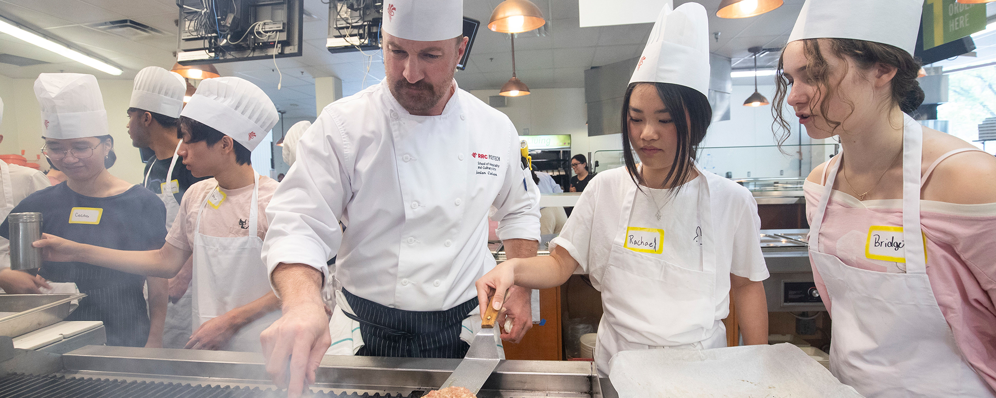 孩子们和厨师一起在烤架上做饭