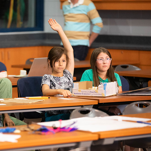 两个女孩，其中一个举手了